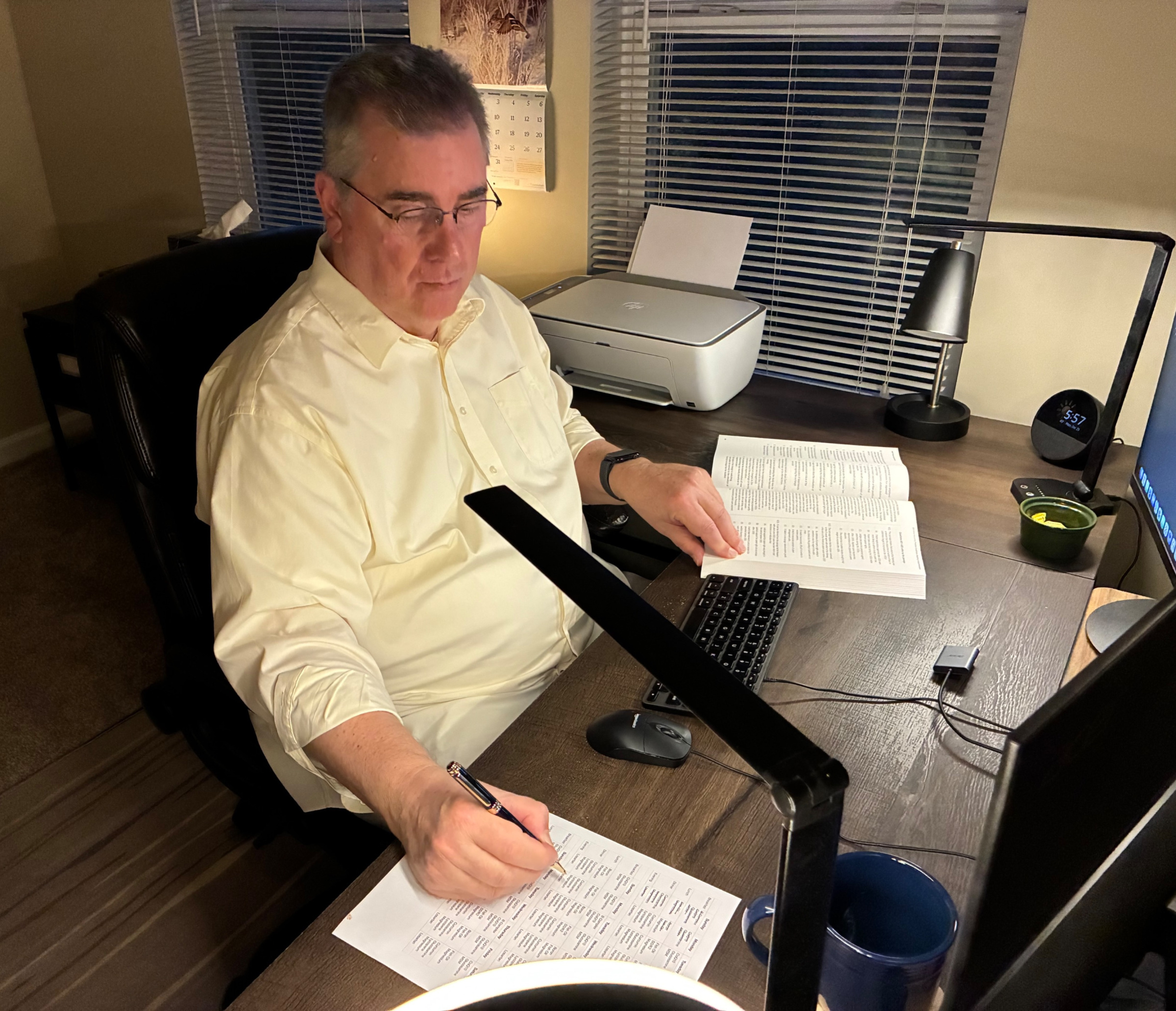 Eric Hallett siting at his desk